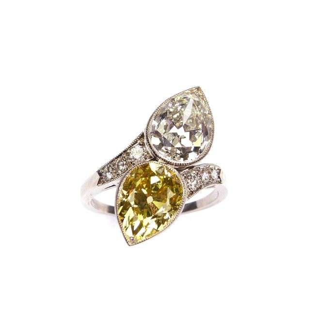 Two stone yellow and white diamond crossover ring, set with a 3.30ct fancy vivid yellow pear diamond opposite a 3.26ct E VS1 pear diamond, | MasterArt
